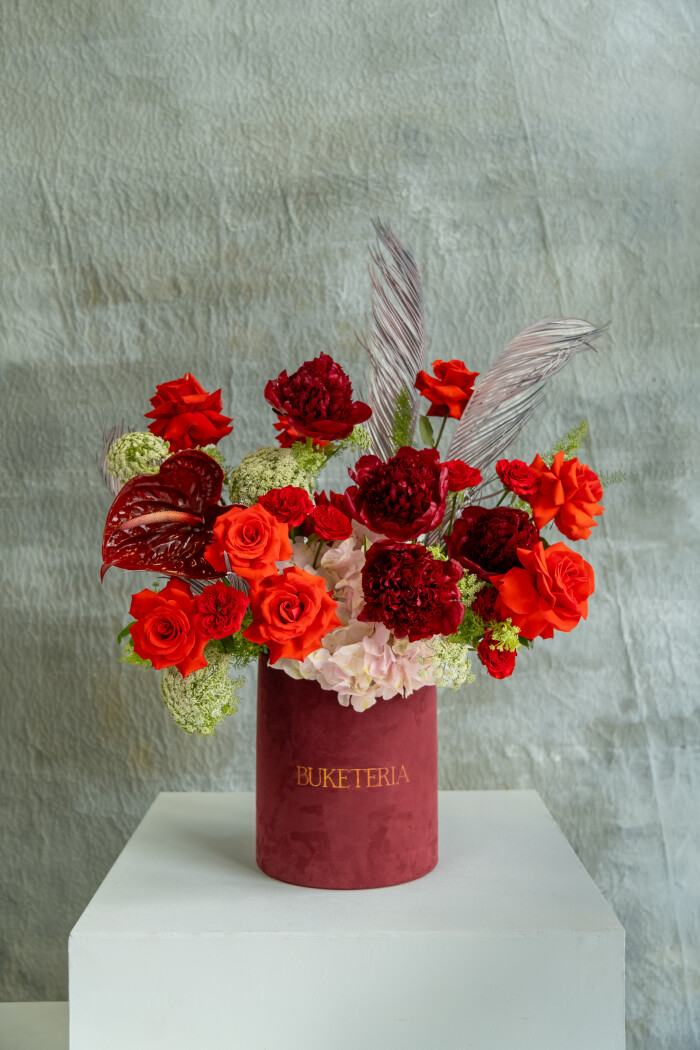 Nine red hybrid tea roses with burgundy peonies