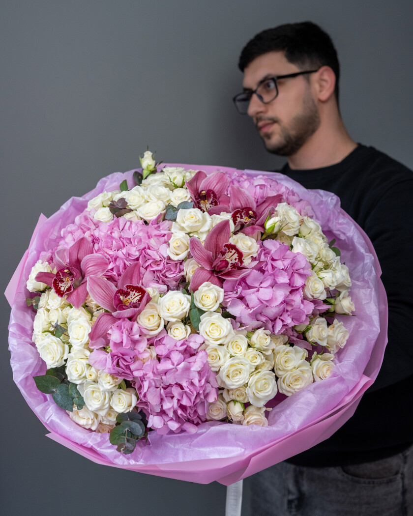 Mixed bouquet of white spray roses, purple cymbidium orchids, and light pink hydrangeas