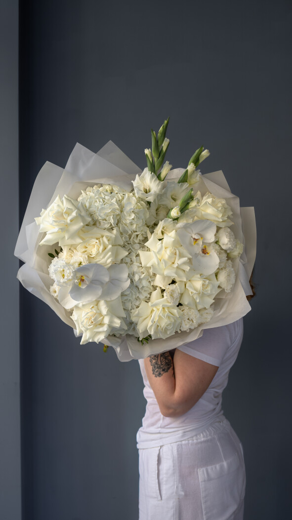 Elegant bouquet of white roses, hydrangeas, and orchids