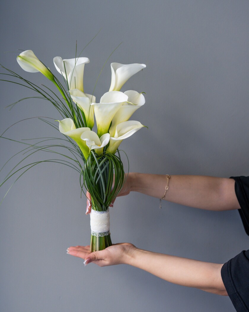 Eleven white callas in a classic hand-tied bouquet