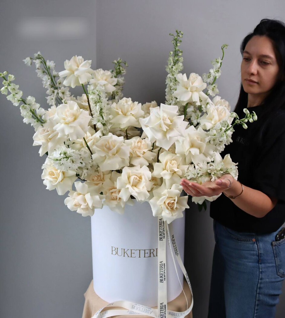 Elegant composition of cream garden roses and white delphiniums