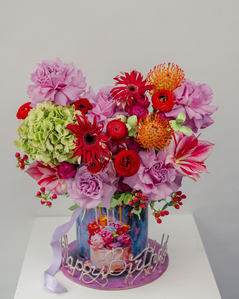 Decorative composition of hot pink ranunculus and red amaryllis