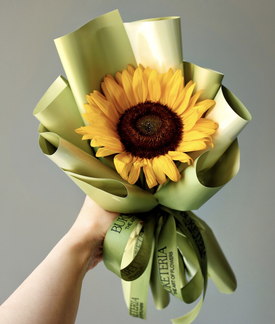 Single yellow sunflower in waterproof paper