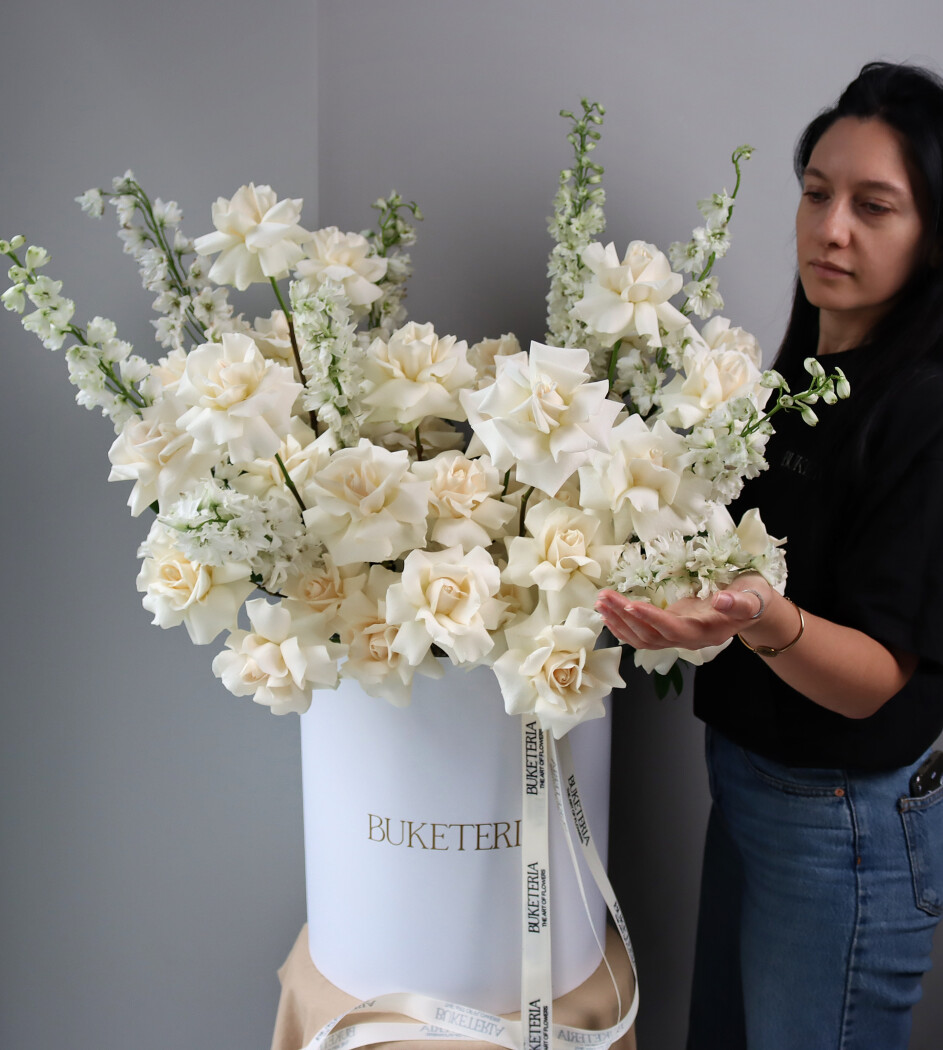 Elegant composition of cream garden roses and white delphiniums