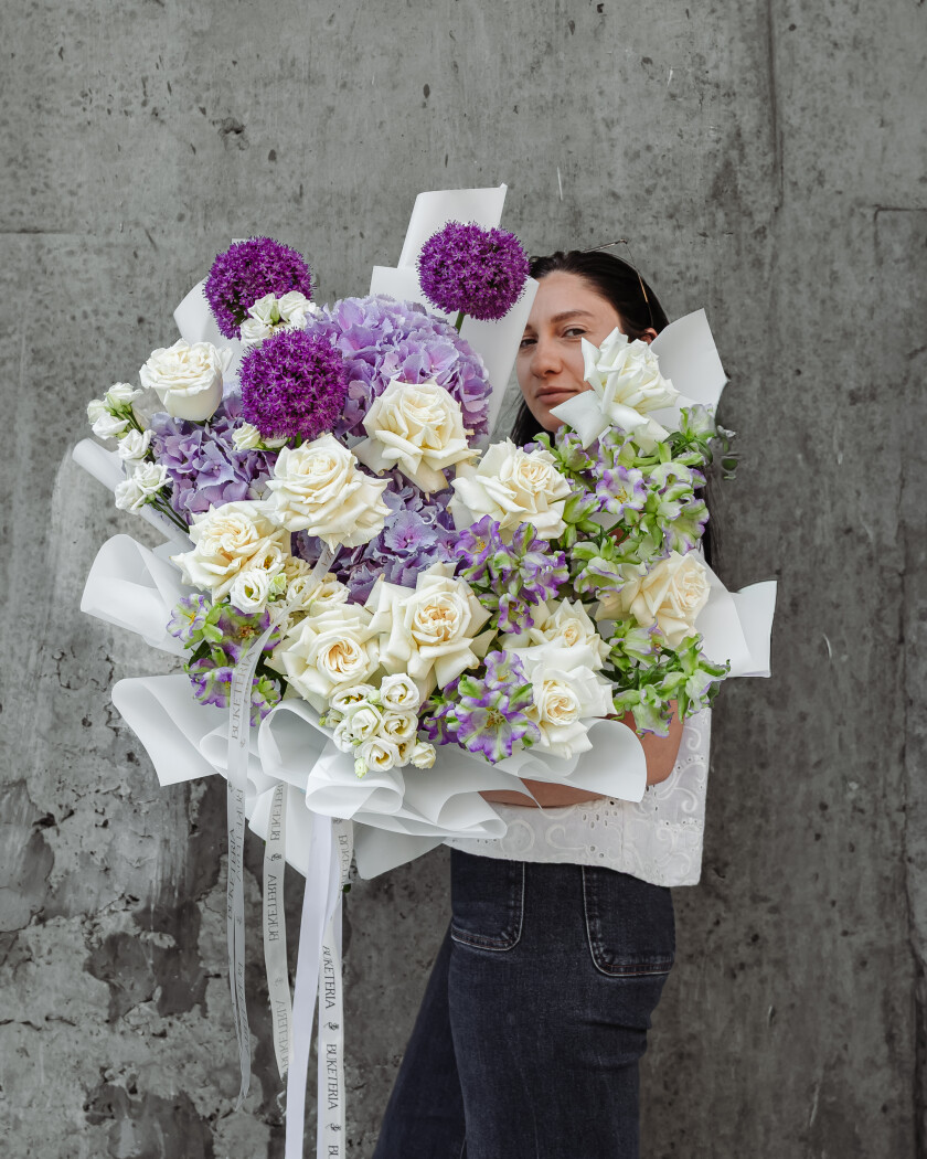 Light blue lisianthus with white roses and lilac hydrangeas
