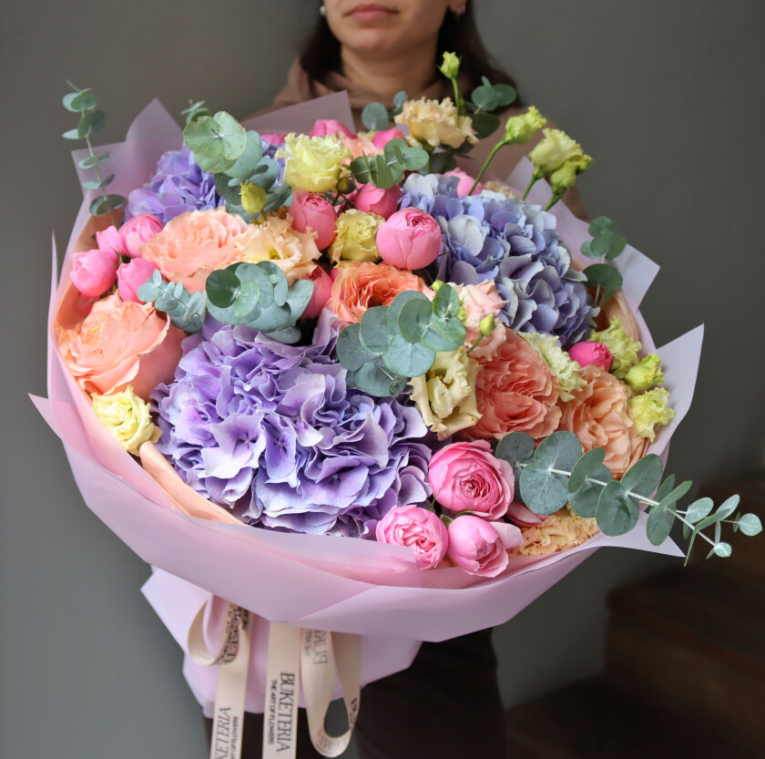 Eleven pink spray roses with light pink lisianthus and lilac hydrangea