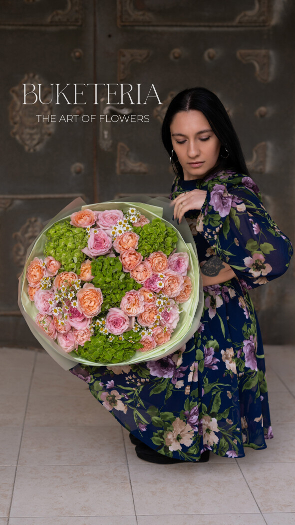 Mixed bouquet of light pink spray roses, green hydrangeas, and peach garden roses