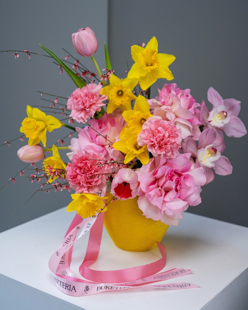 Decorative arrangement of blush garden roses and light pink tulips