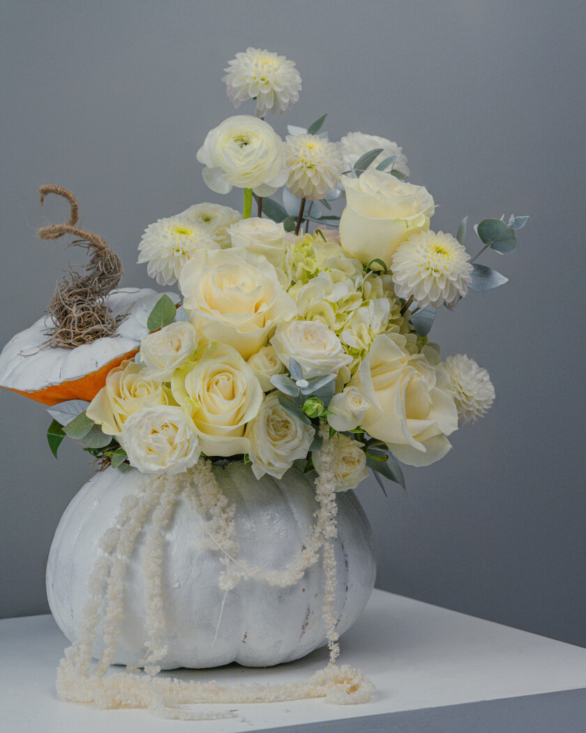 Cream roses with white ranunculus and green accents