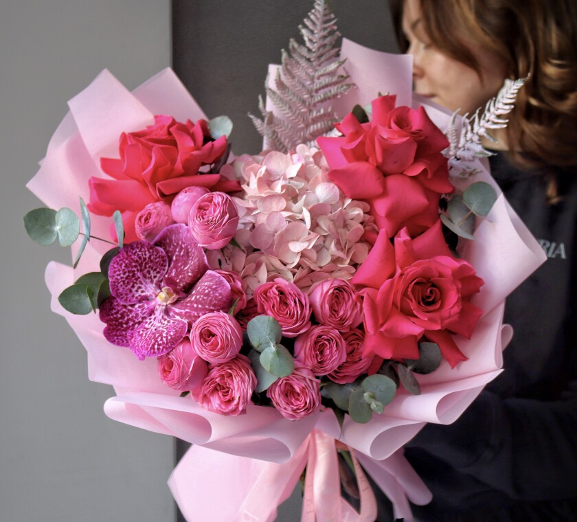 Four pink spray roses with hot pink garden roses and hydrangea