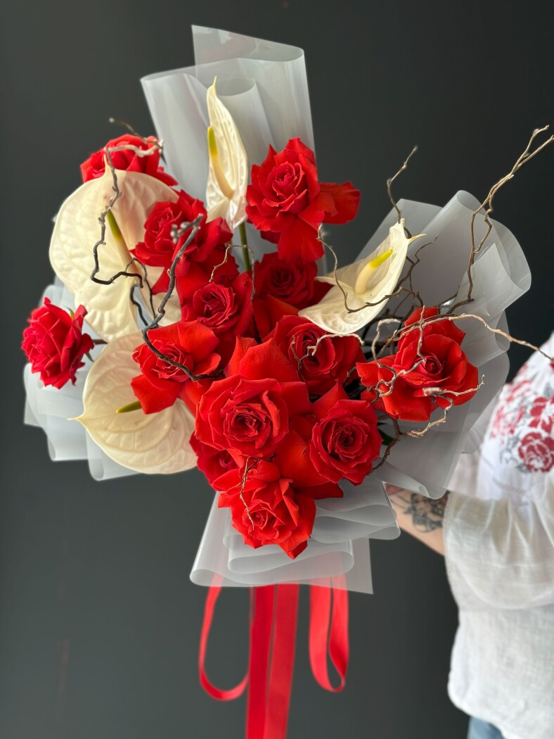 Thirteen red hybrid tea roses with white anthuriums