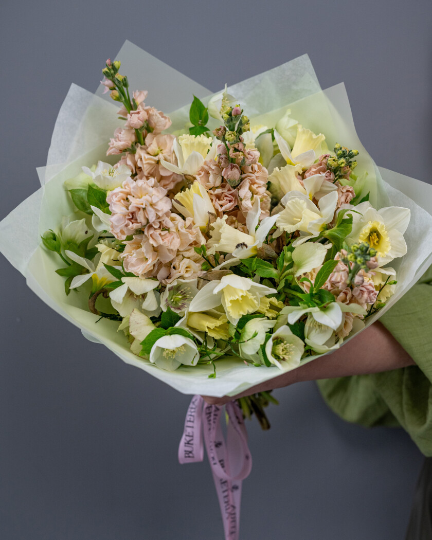 Spring bouquet of white hellebores, blush stock, and cream narcissus