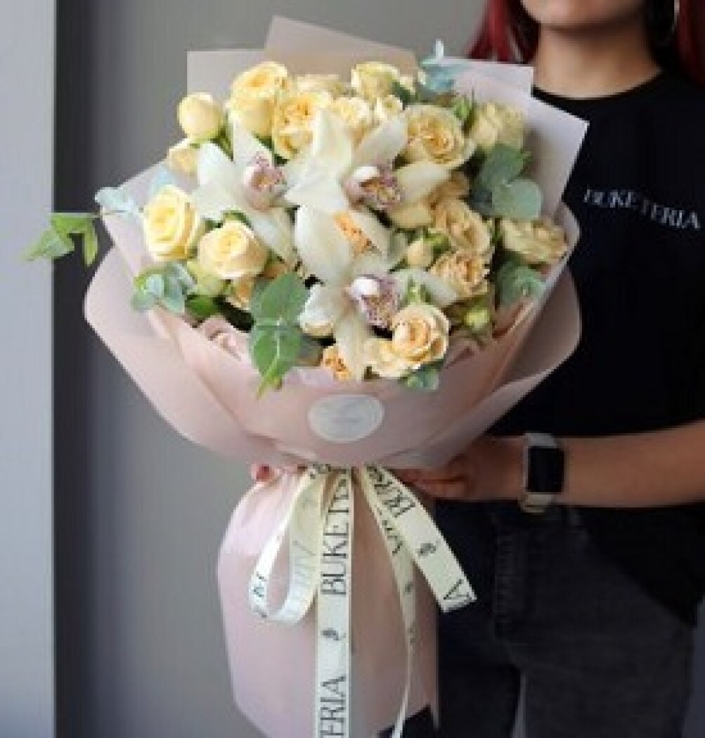 Five cream spray roses with three white cymbidium orchids