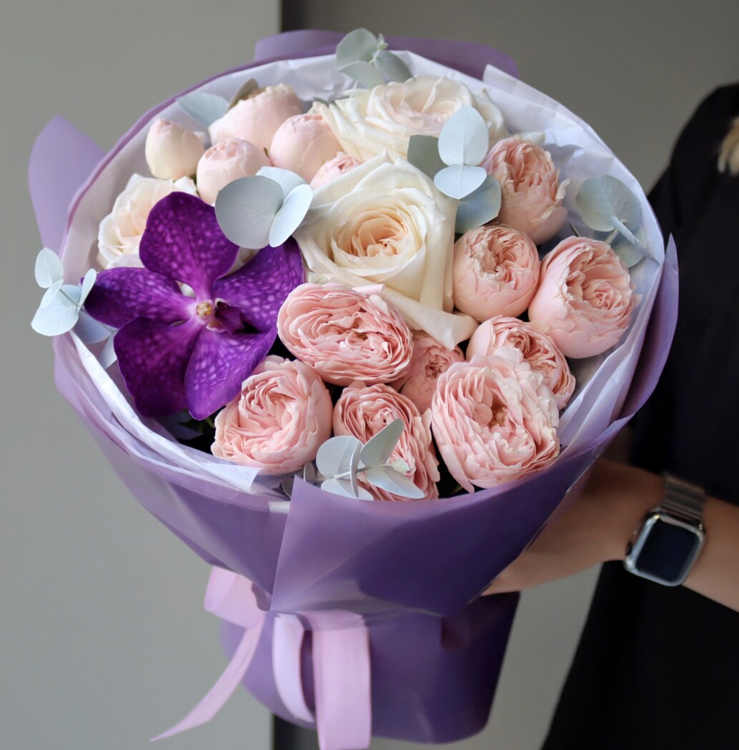 Blush spray roses with cream garden roses and purple vanda orchid