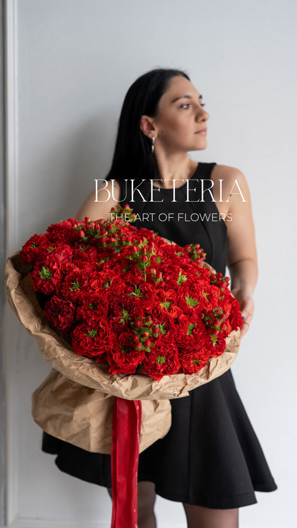 Fifty-one red garden roses in kraft paper