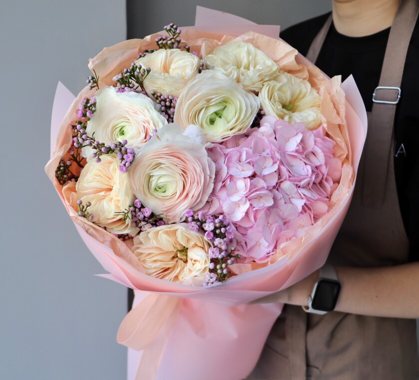 Blush ranunculus with peach spray roses and pink hydrangea