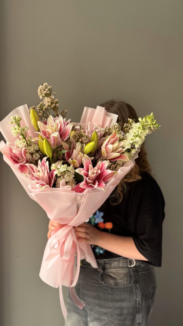 Mixed bouquet of light blue delphiniums and pink oriental lilies