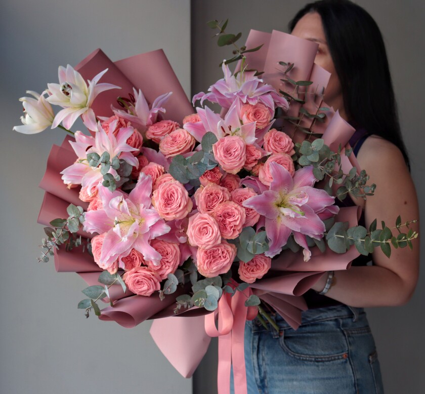 Seven peach spray roses with four light pink oriental lilies