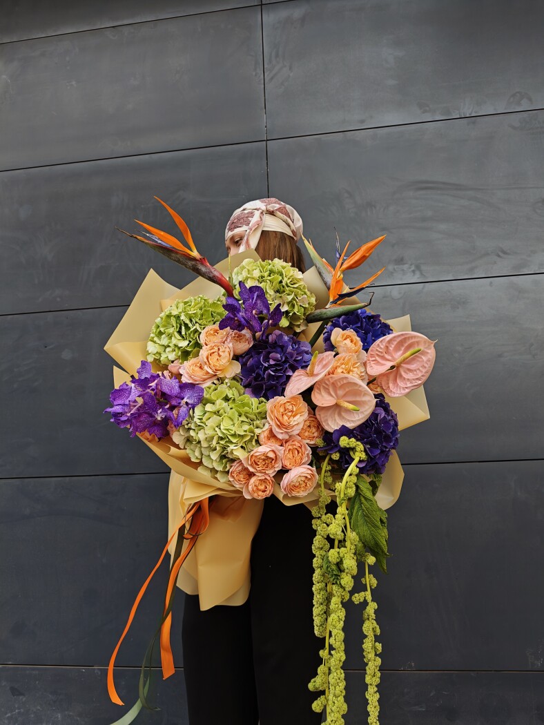 Lilac hydrangeas with vanda orchids and peach roses