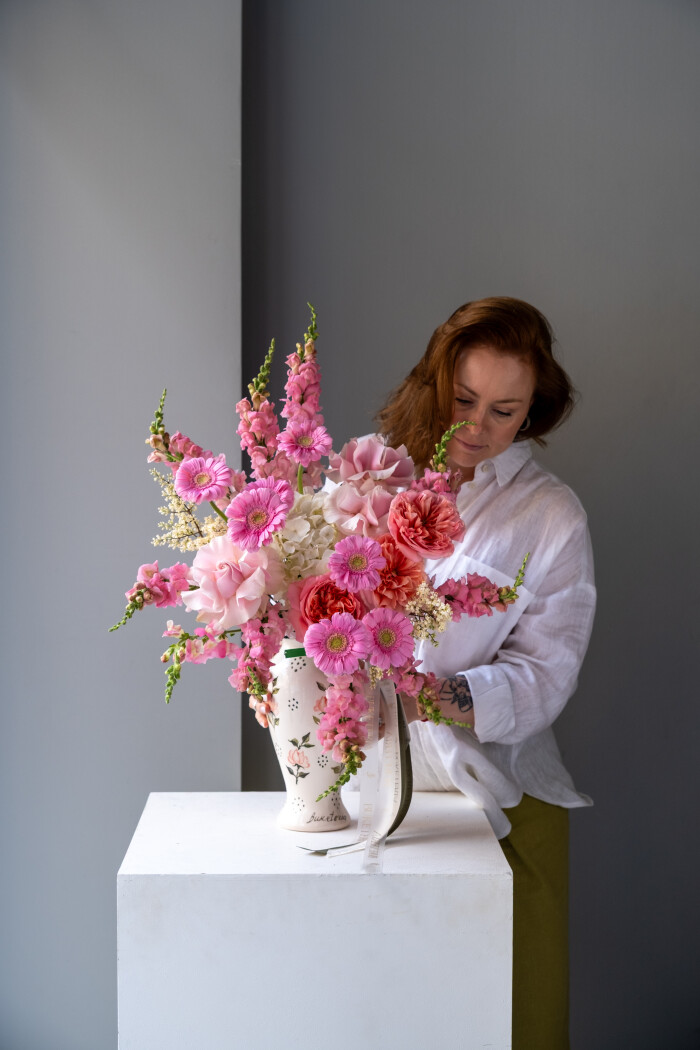 Coral gerberas and peach garden roses in a vase