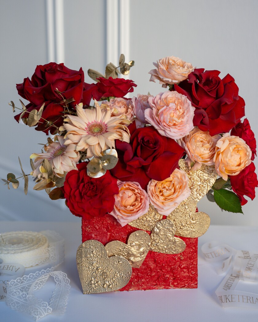 Two red spray roses with three peach hybrid tea roses