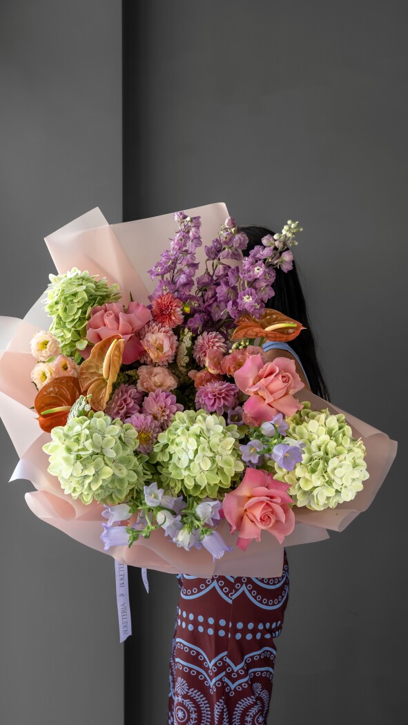 Four green hydrangeas with orange anthuriums and peach dahlias