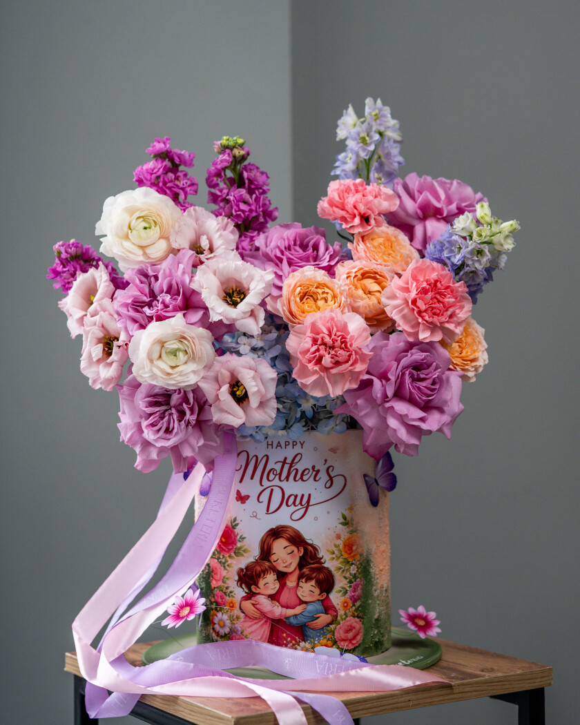 Five mauve garden roses with blue delphiniums and white with pink lisianthus